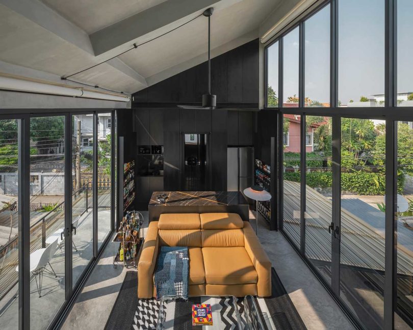 interior shot of modern living room flanked by two walls of windows