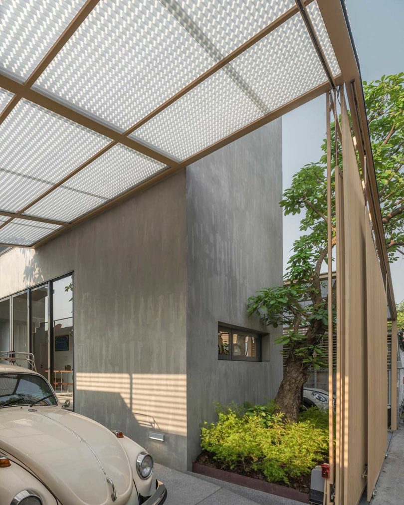 angled exterior view of modern bangkok home behind gate