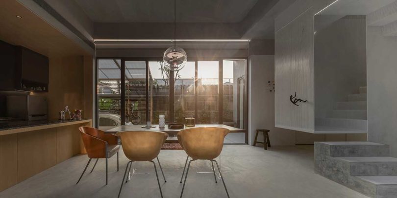 interior shot of modern home living room with dining table looking out to window