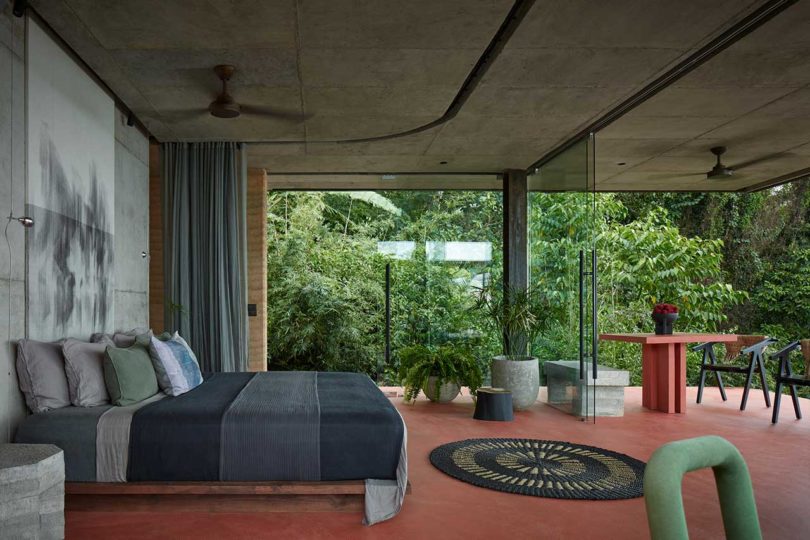 side view of modern bedroom looking out to tropical landscape