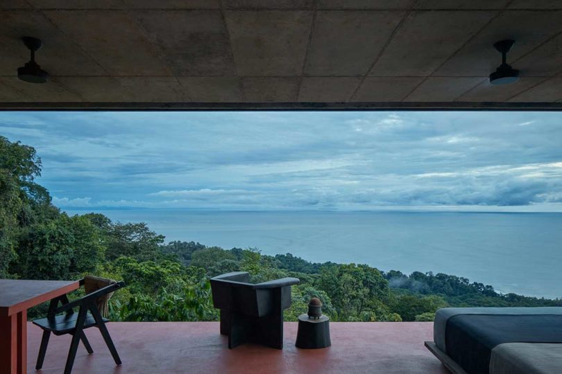 modern villa with red floors looking out to tropical landscape