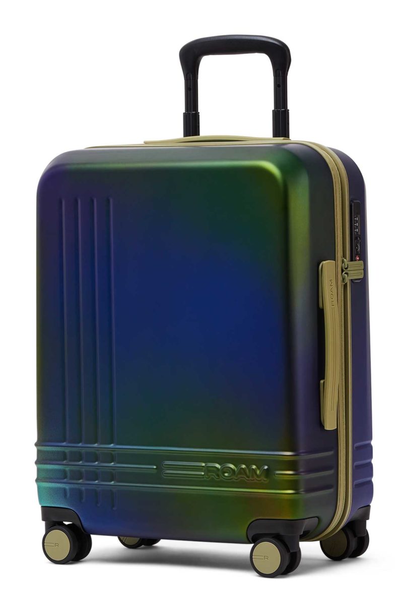 Angled view of iridescent blue green suitcase