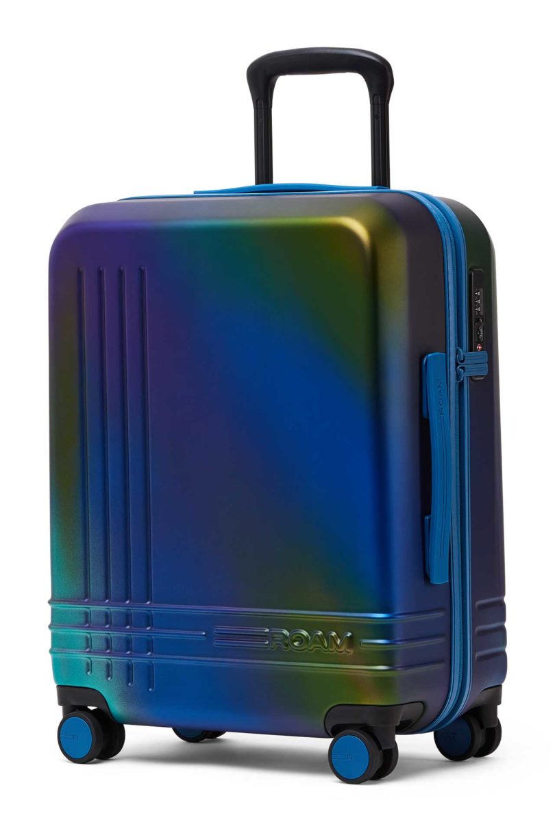 Angled view of iridescent blue green suitcase