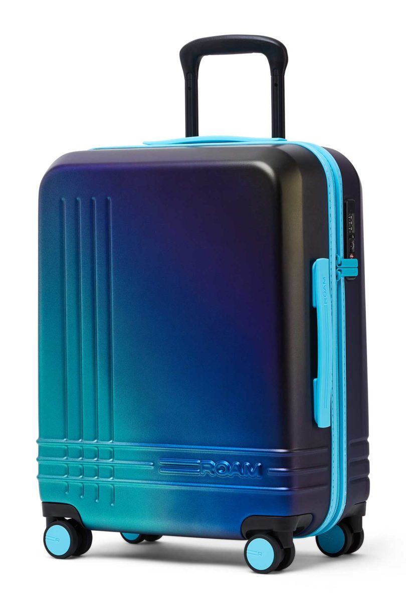 Angled view of iridescent blue green suitcase