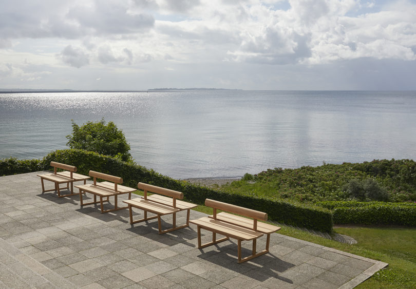 four simple wooden double-sided benches in the outdoors