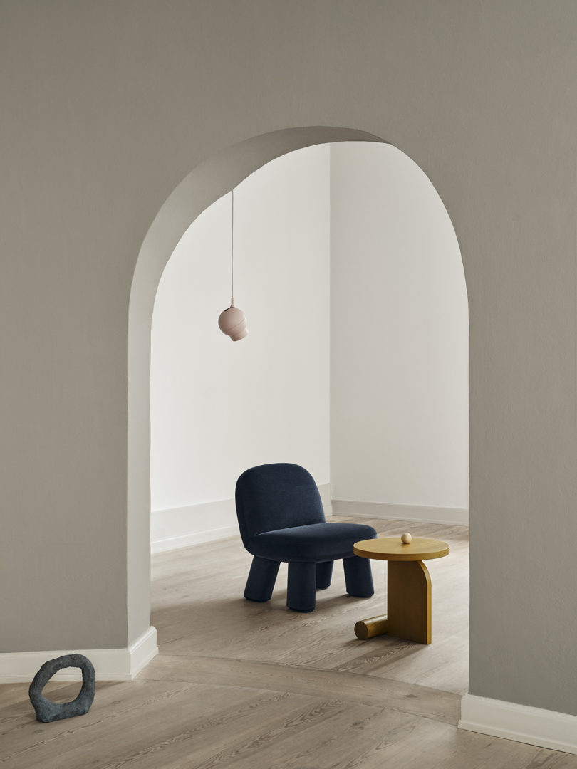 modern chair and side table in an empty interior space