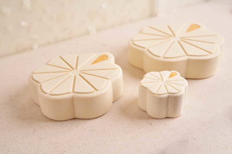 three sculptural beige pastries