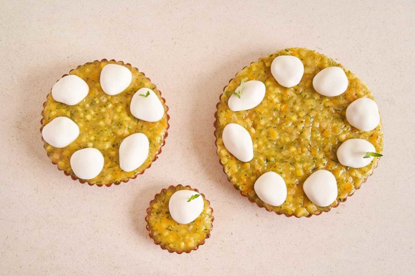 three different sized pastries with white dollops 