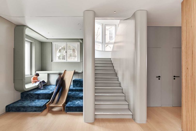 interior view of modern house with multi level kids space with a slide and staircase