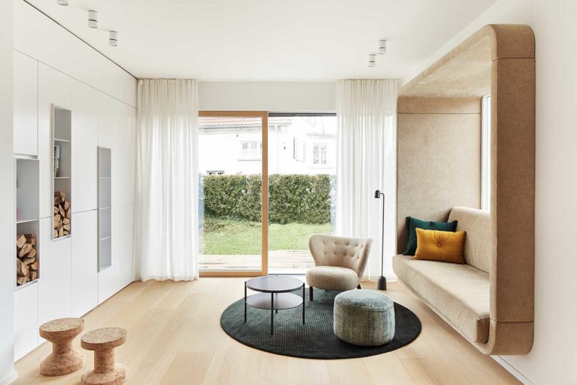 interior shot of modern living room with white built-in cabinets and a built-in sofa