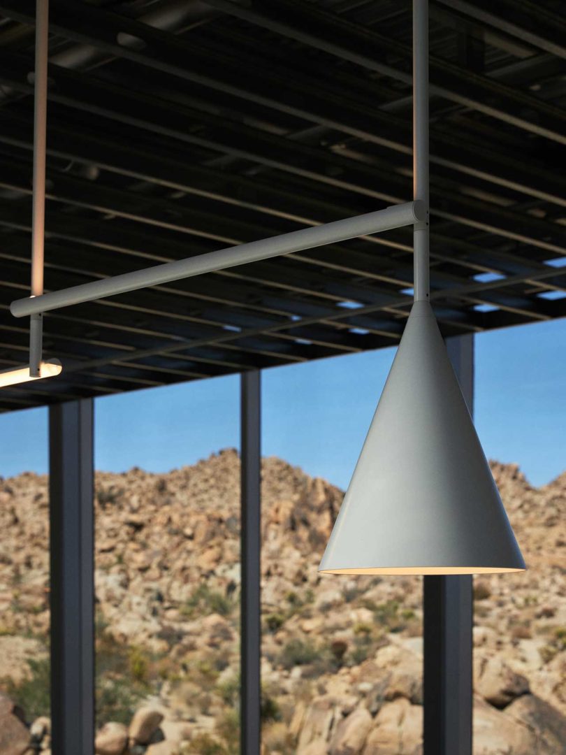 angled interior view of modern house with triangular concrete hanging lamp