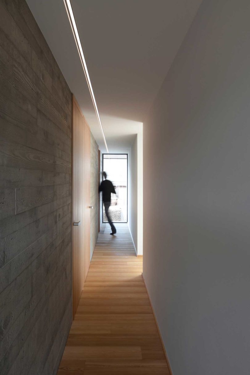 view down long hallway with man walking