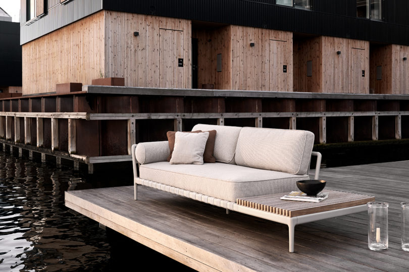 outdoor sofa with open end styled on a dock