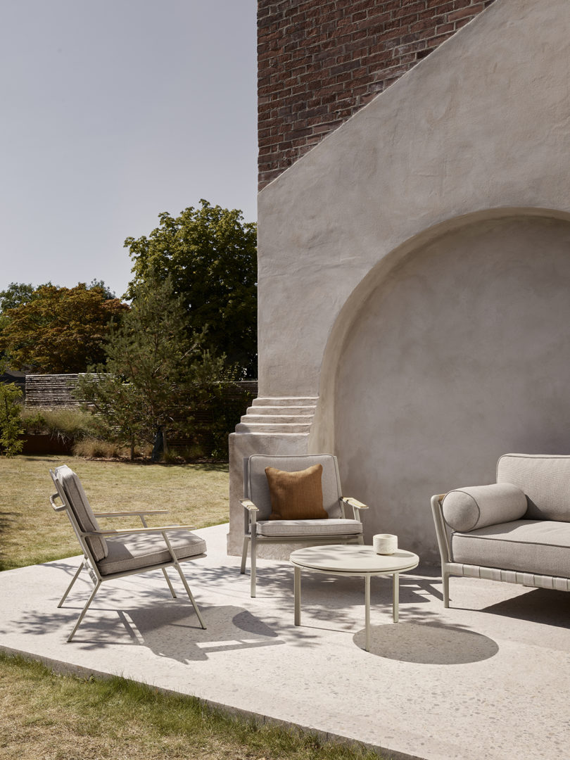 two outdoor lounge chairs, sofa, and coffee table styled