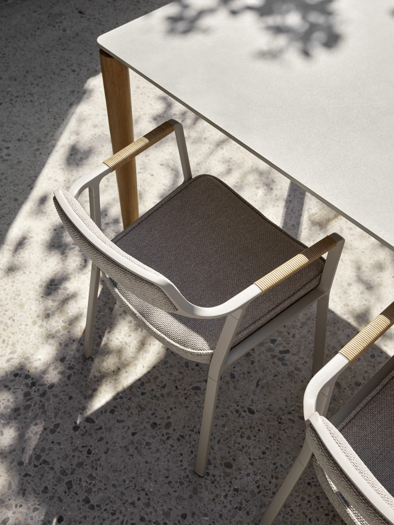 outdoor dining table and two armchairs styled