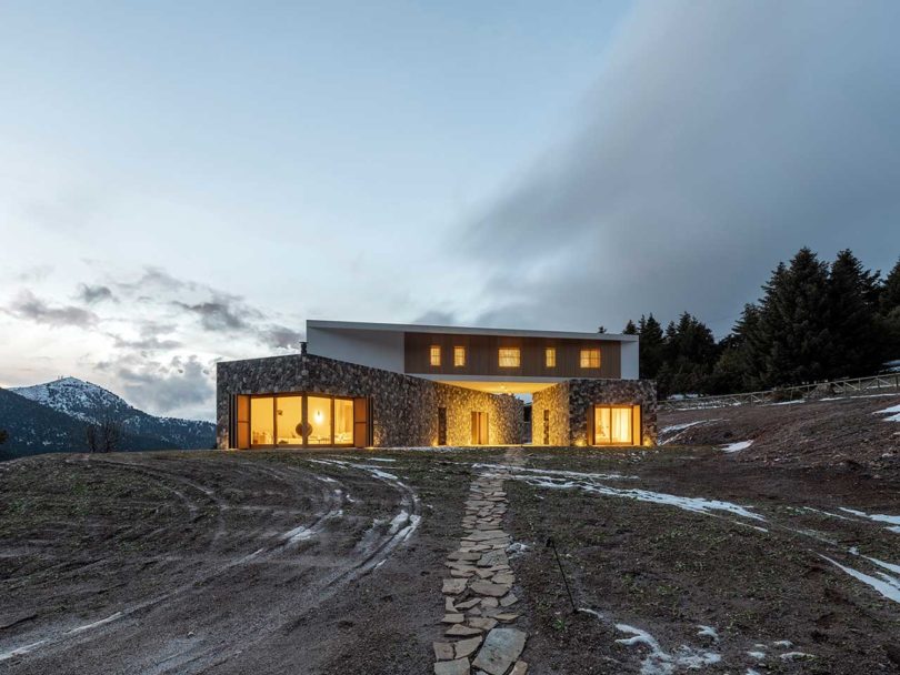 evening view of modern mountain house with lights on