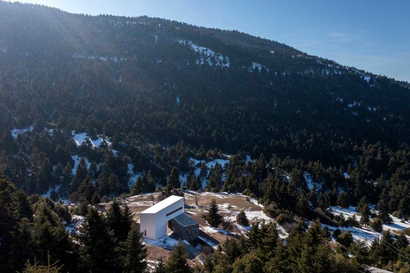 sky view of modern stone and white mountain house