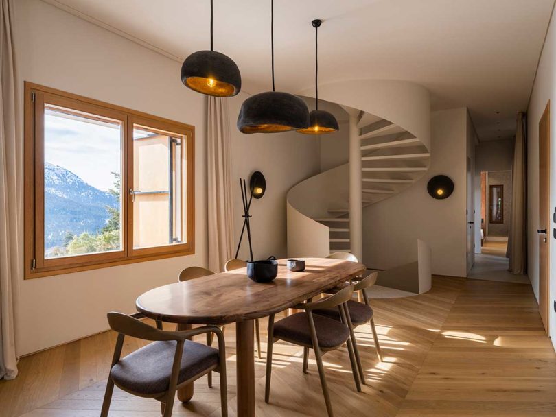 angled view of modern dining room with spiral staircase