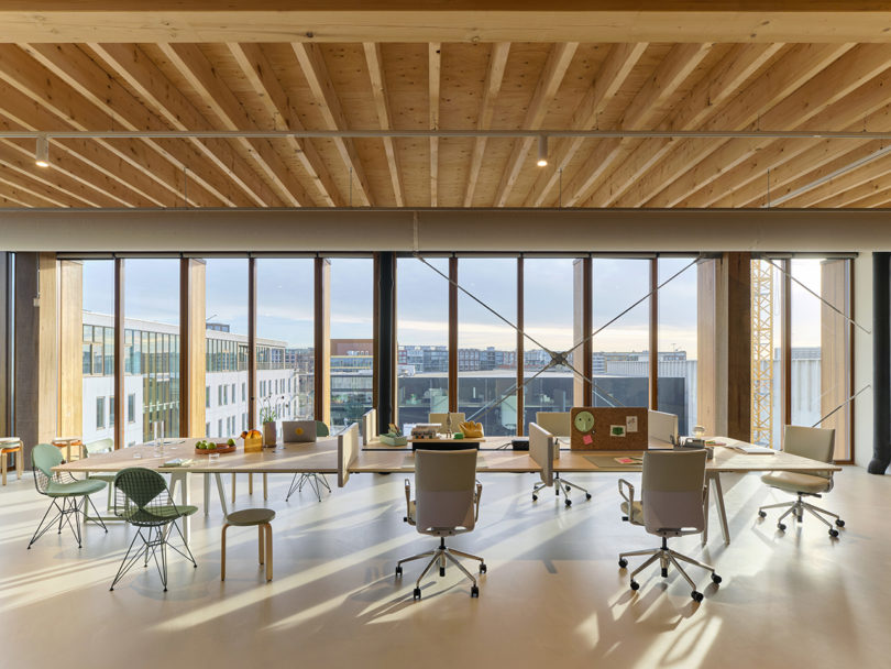 open office space with large table and rolling chairs