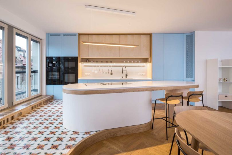 modern kitchen with organic island and blue cabinets