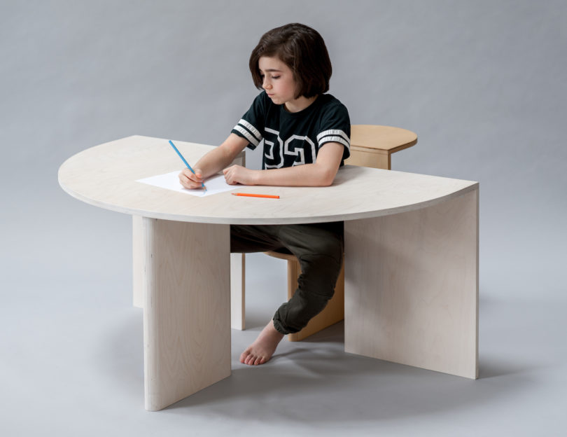 child sitting at arch table