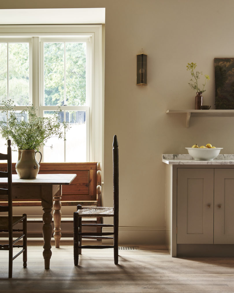 The Plain English-designed guest kitchen in the farmhouse, featuring a classic AGA stove and rustic wood accents