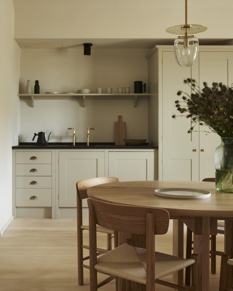 Interior of a cabin at INNESS, highlighting custom furniture, stocked kitchenette, and ample socializing space