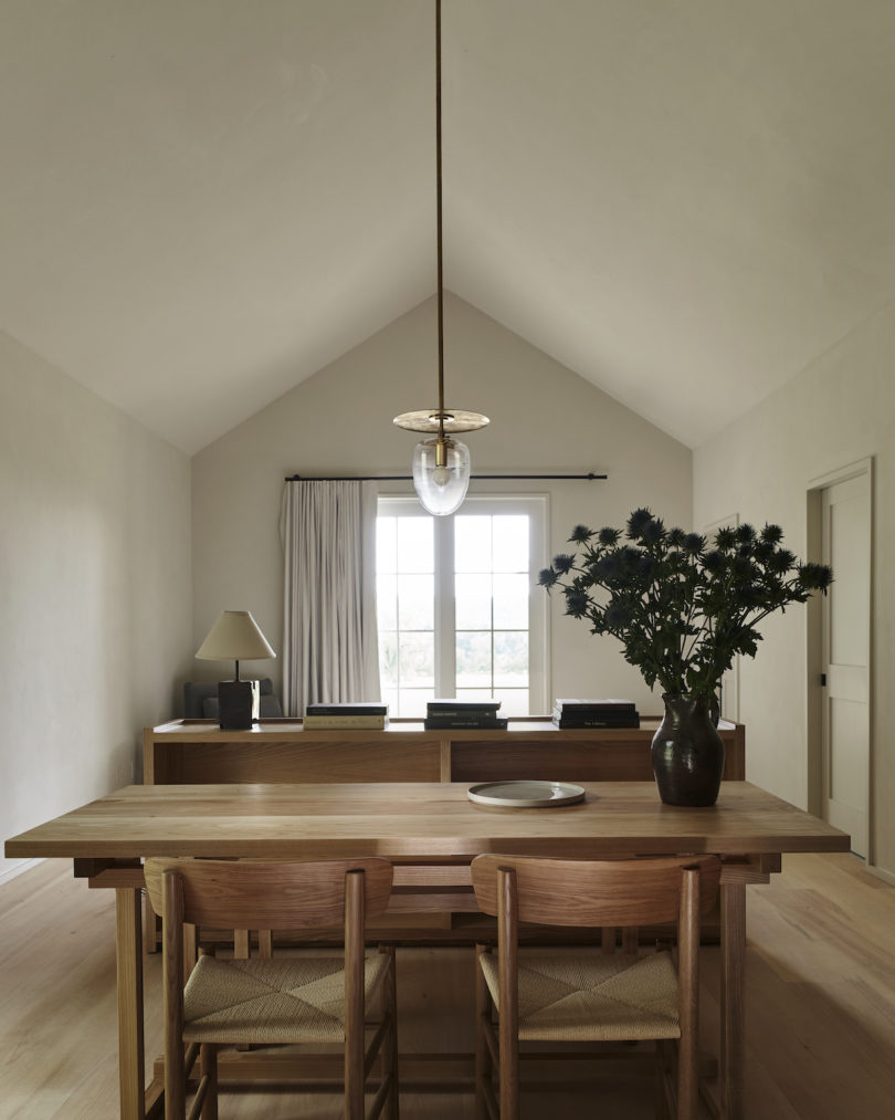 Interior of a cabin at INNESS, highlighting custom furniture, stocked kitchenette, and ample socializing space