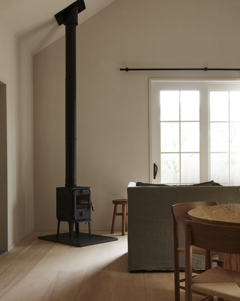 Interior of a cabin at INNESS, highlighting custom furniture, stocked kitchenette, and ample socializing space