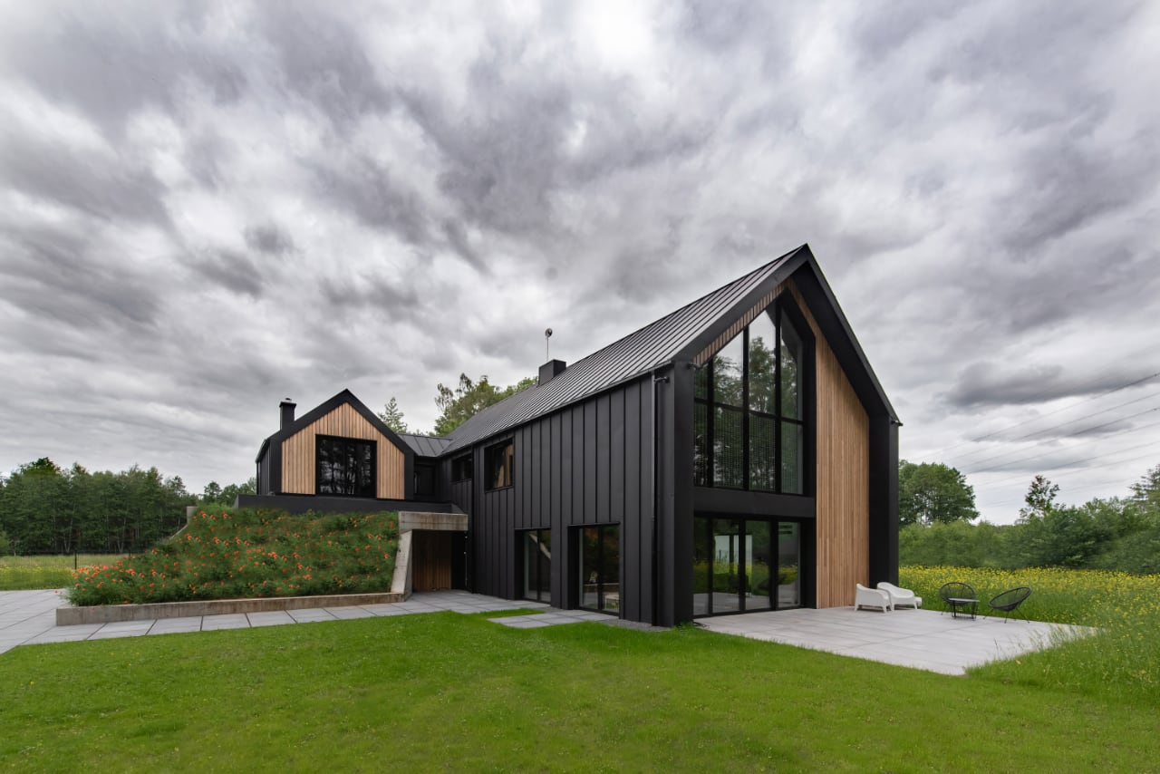 The Hilltop House Cleverly Hides a Garage Underneath Grassy Slopes