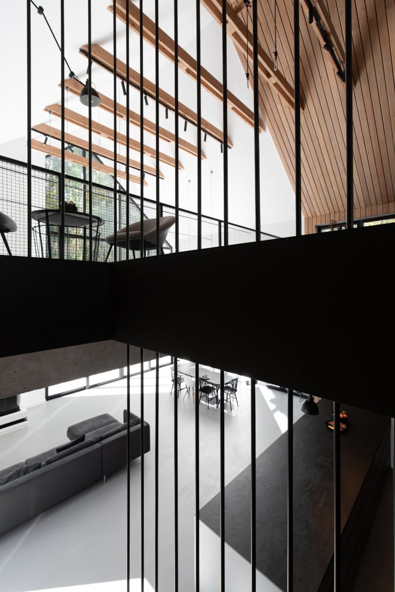 angled view from open staircase looking to downstairs living room and upstairs sitting room