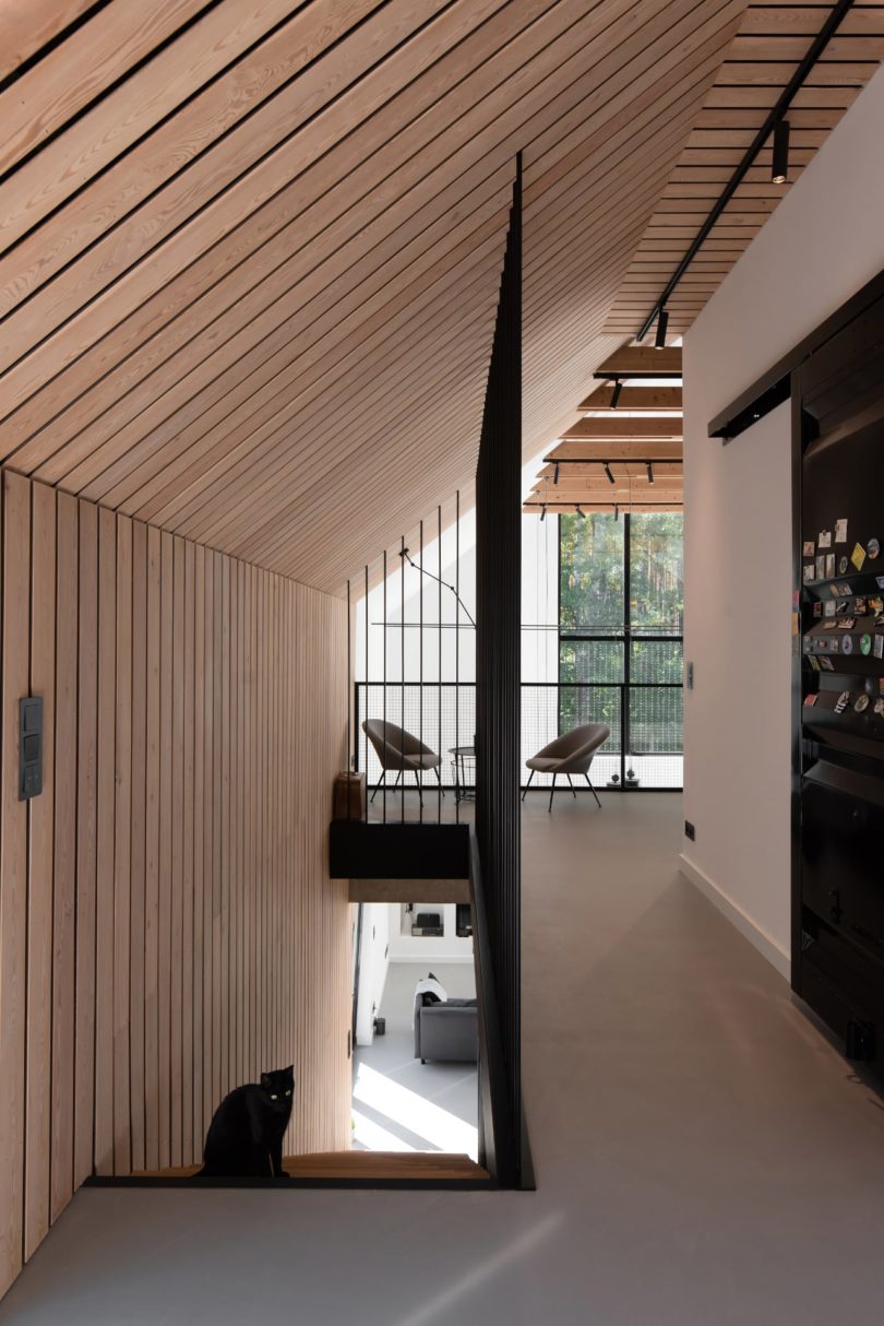 upstairs interior view of modern house looking at down staircase and hallway towards loft