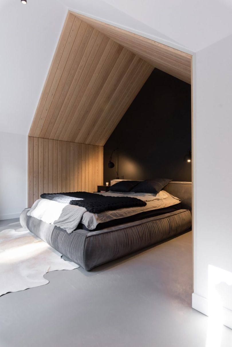 view into pitched roof bedroom nook with black wall