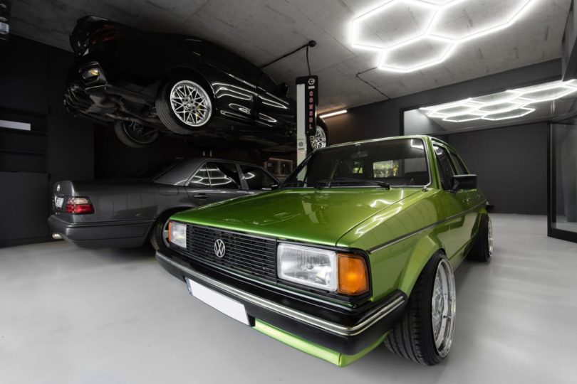 view through modern black garage with green card