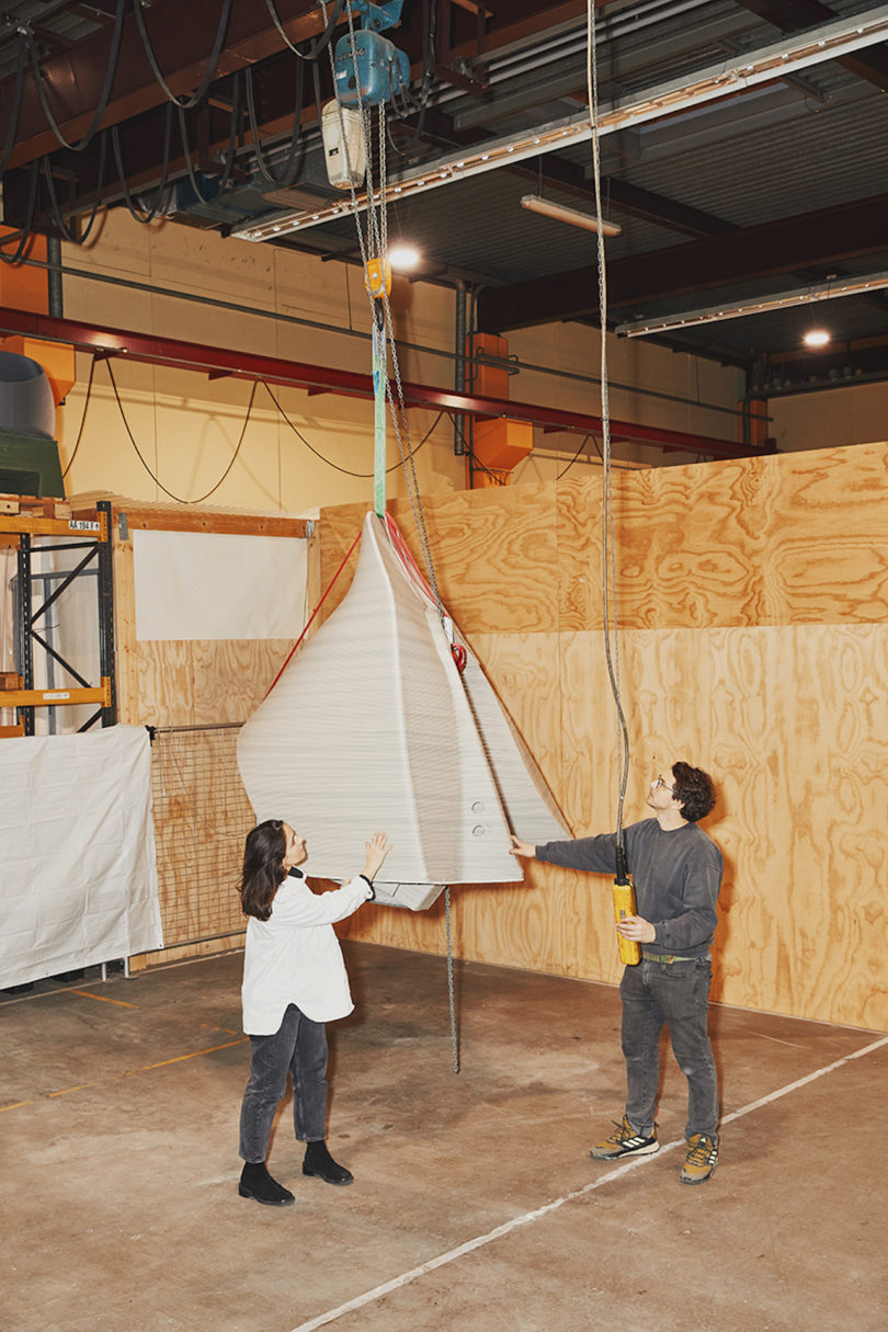 two designers standing next to 3d printed furniture