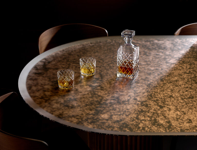 round surface with a crystal liquor decanter and two tumblers