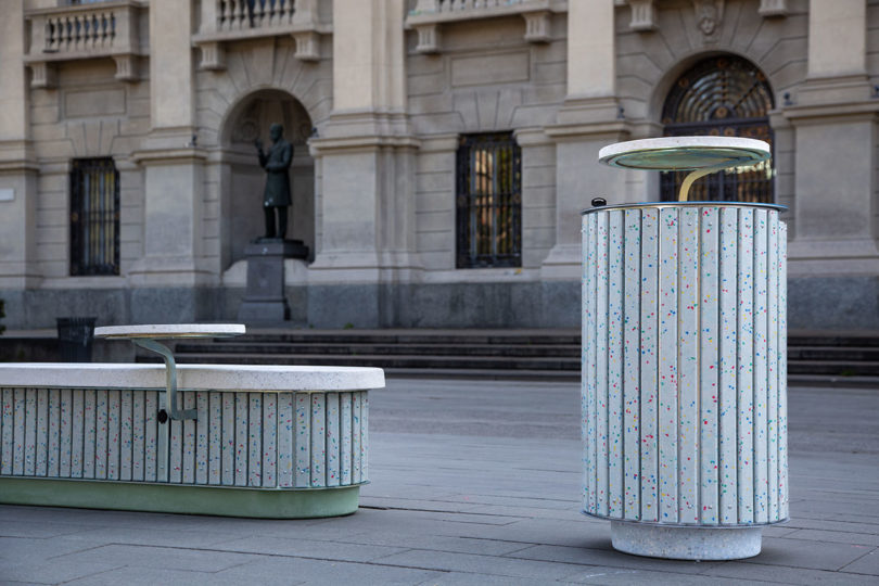 outdoor cement bench and garbage can