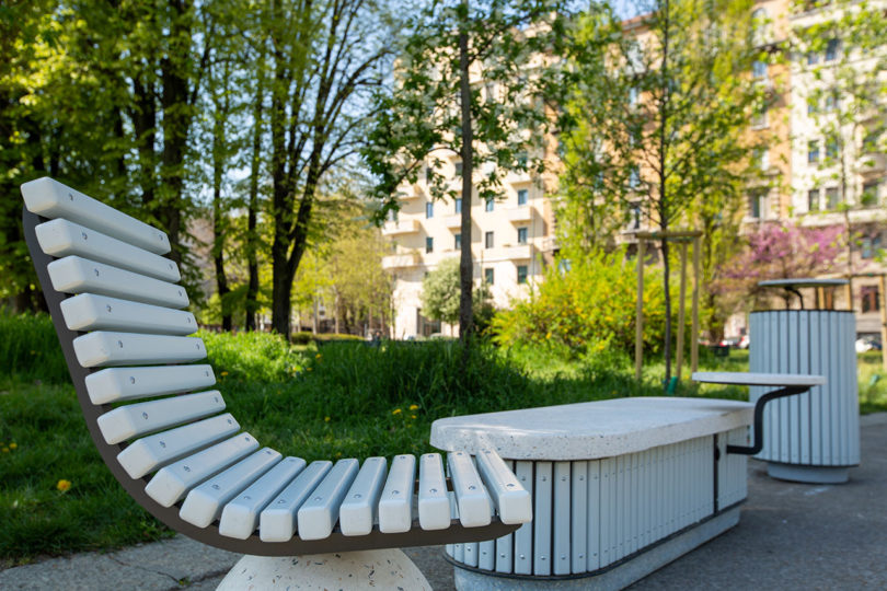 outdoor cement chair, bench, and garbage can