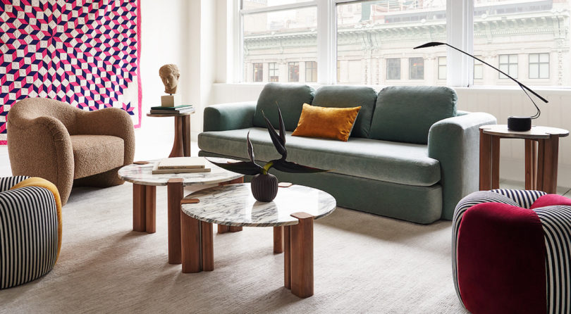 styled interior space with sofa and two coffee tables