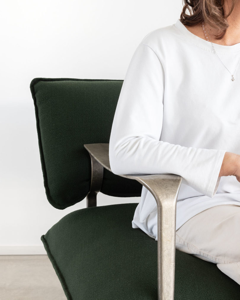 detail of curved modern sofa with silver arms and legs