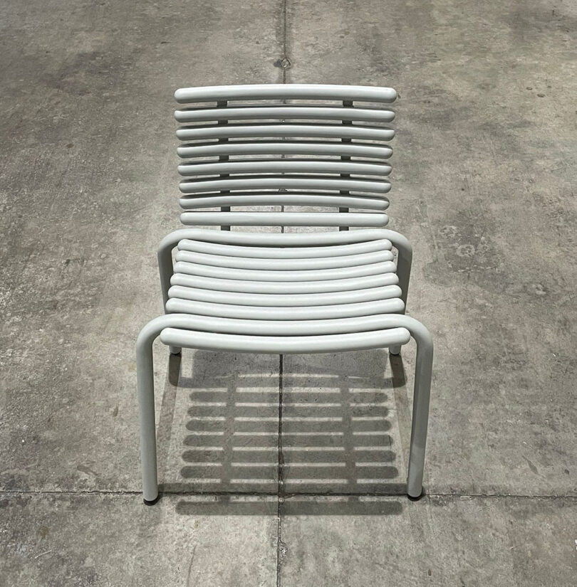 modern white outdoor chair prototype in a warehouse