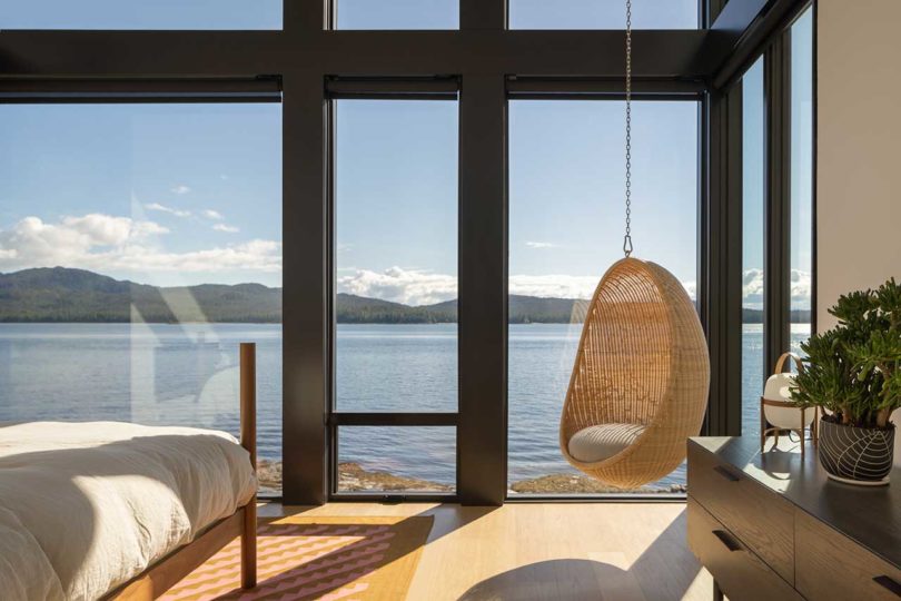 interior view of modern bedroom with windows that look out to water