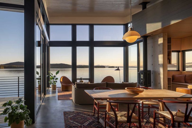 interior view of modern living space with dining room and living room overlooking the water