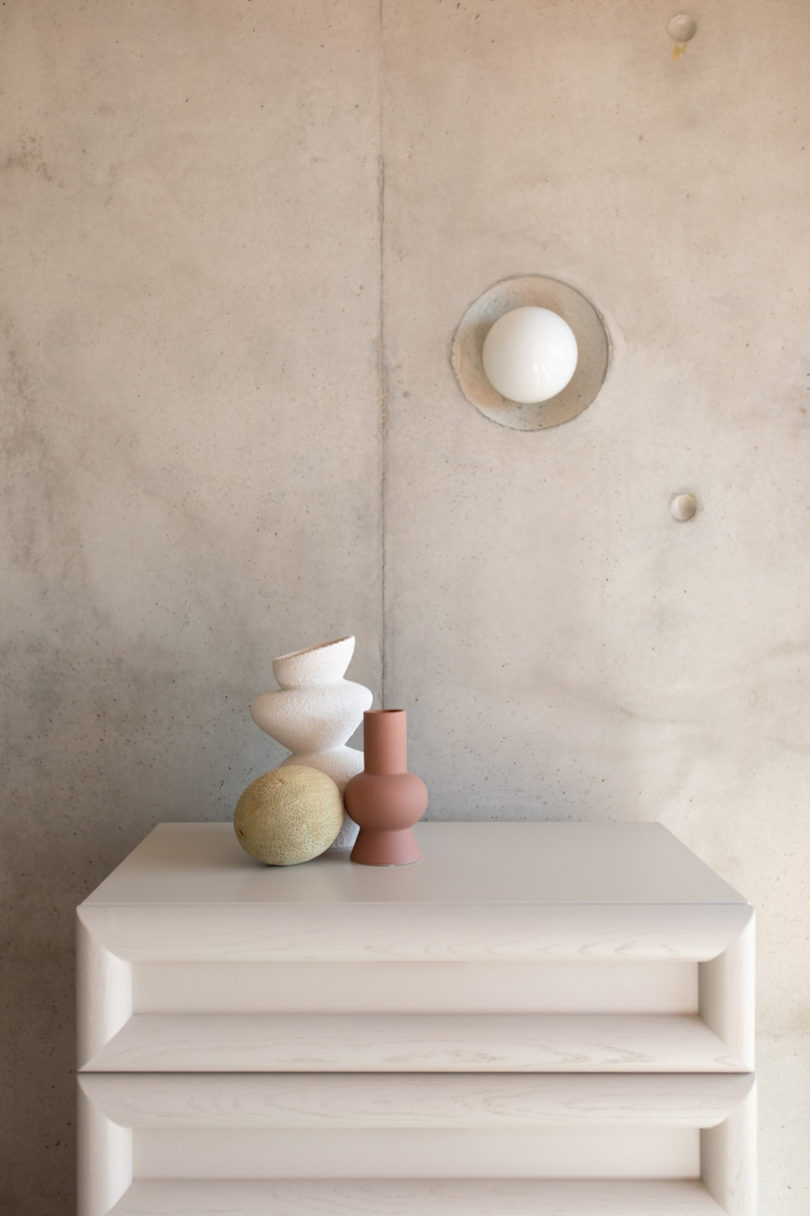 beige dresser with vases on top