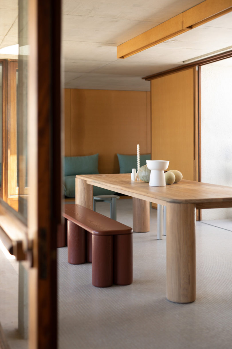 rounded dining table with maroon bench seating