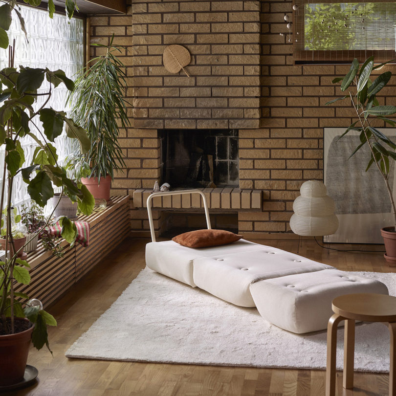 white chair folded out into a bed in living room