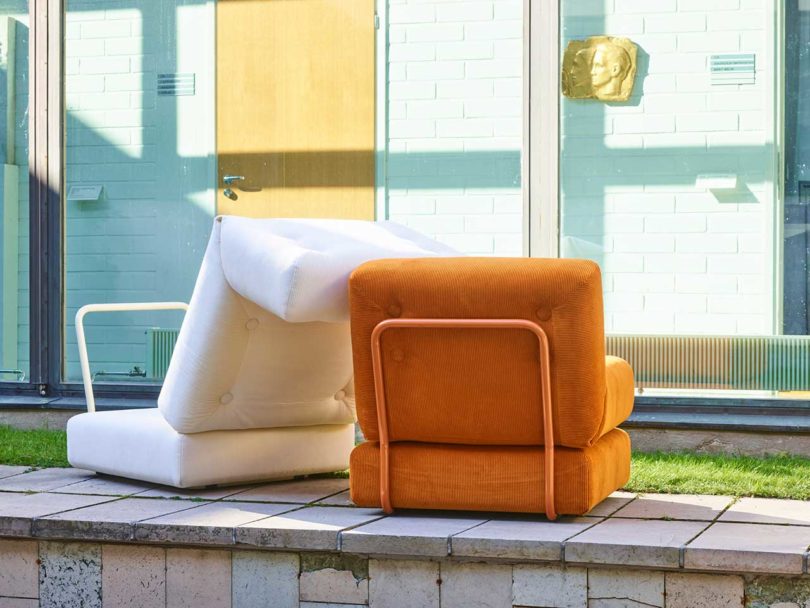 back view of orange corduroy chair with opened white chair