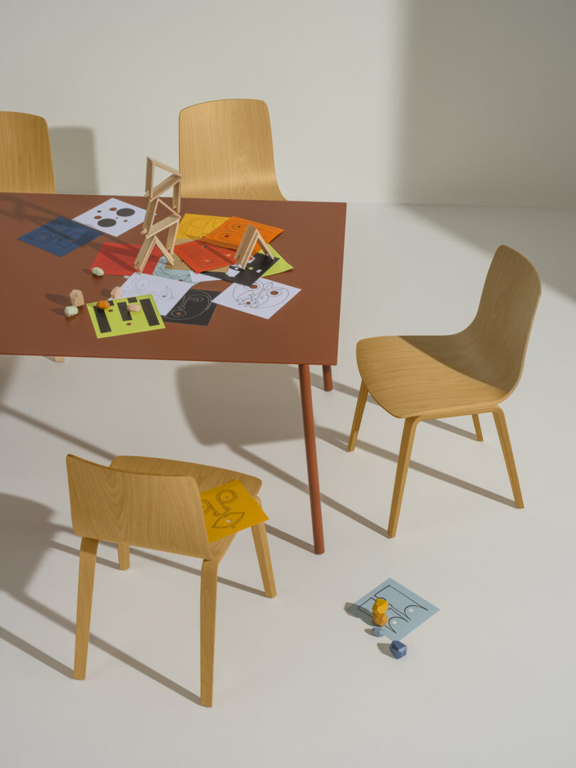 wood veneer covered office chairs surround a large table