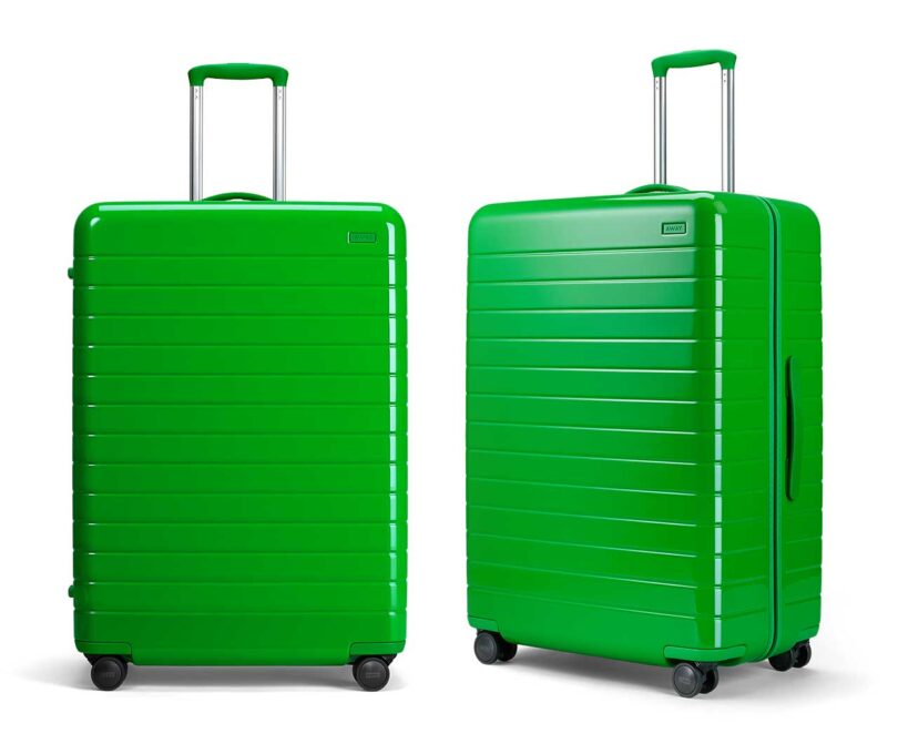 two side by side neon green suitcases one facing front and one at an angle