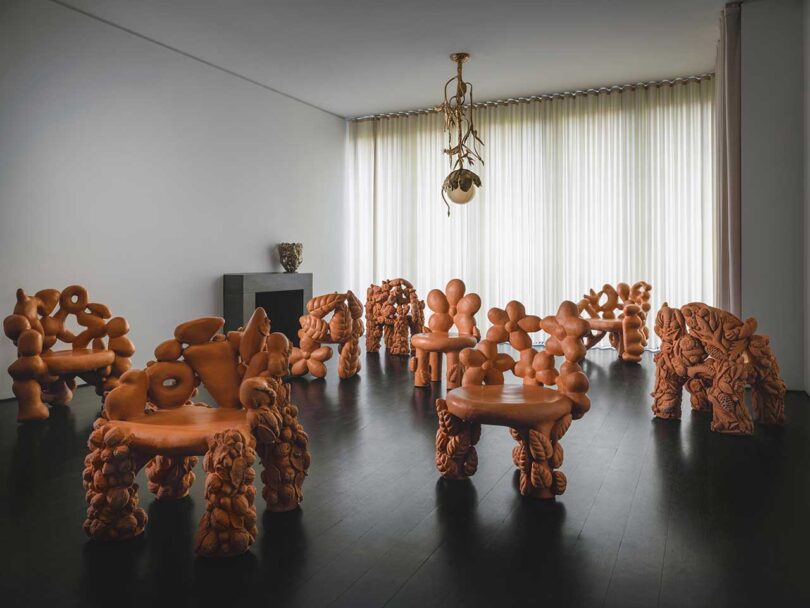 interior space with large terracotta flower themed furniture pieces on display